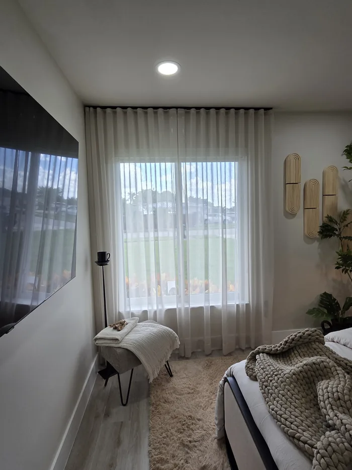 Dormitorio sereno con cortinas sheer y luz filtrada